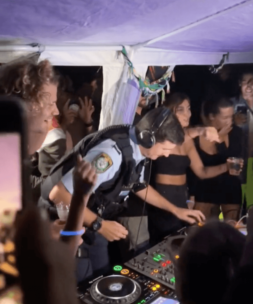 Police Officer Swaps Handcuffs For Headphones At Australian Beach Rave